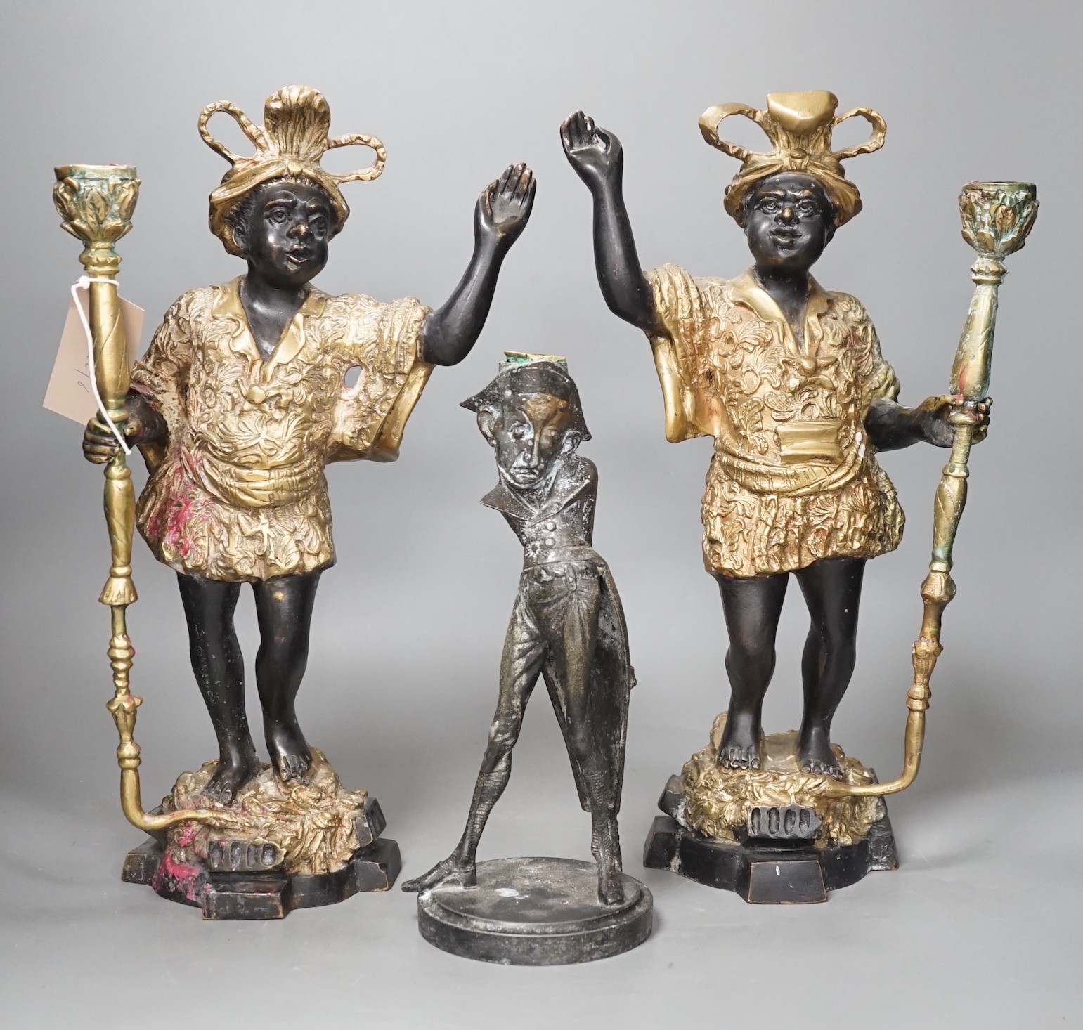 A pair of bronze blackamoor candlesticks and one other spelter figural candlestick, tallest 39cm